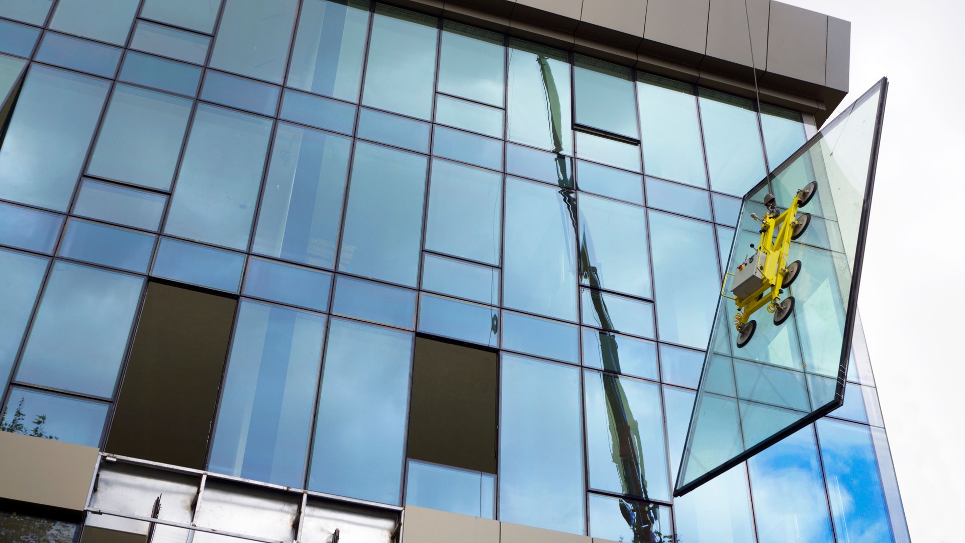 Crane and Glasswork at building site